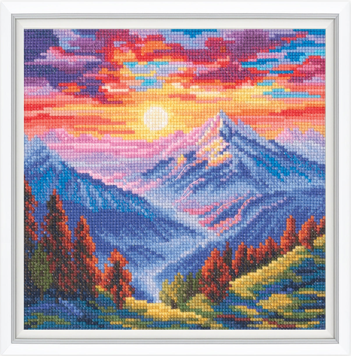 Cross-stitched landscape of mountains and sunset with vibrant colors.