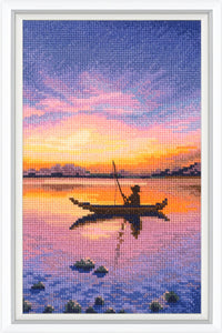Cross-stitched artwork of a silhouette of a person in a kayak at sunset.