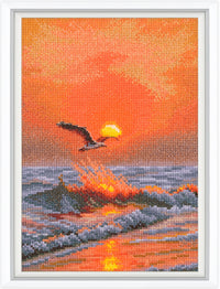 Cross-stitched artwork of a sunset scene with a bird flying over water.